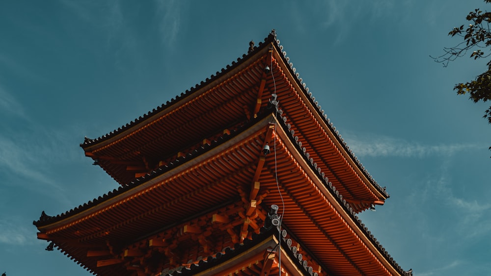 a tall building sitting under a blue sky