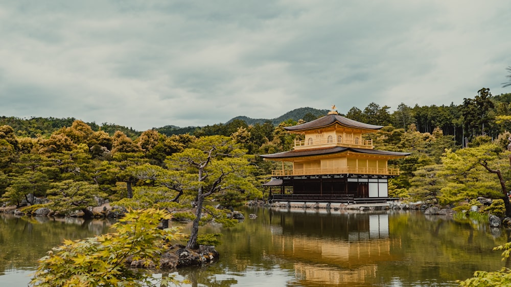 a golden building sitting on top of a lake