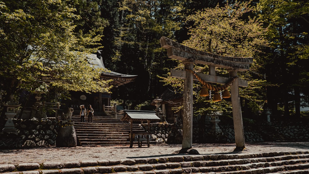 a group of people standing in front of a wooden structure