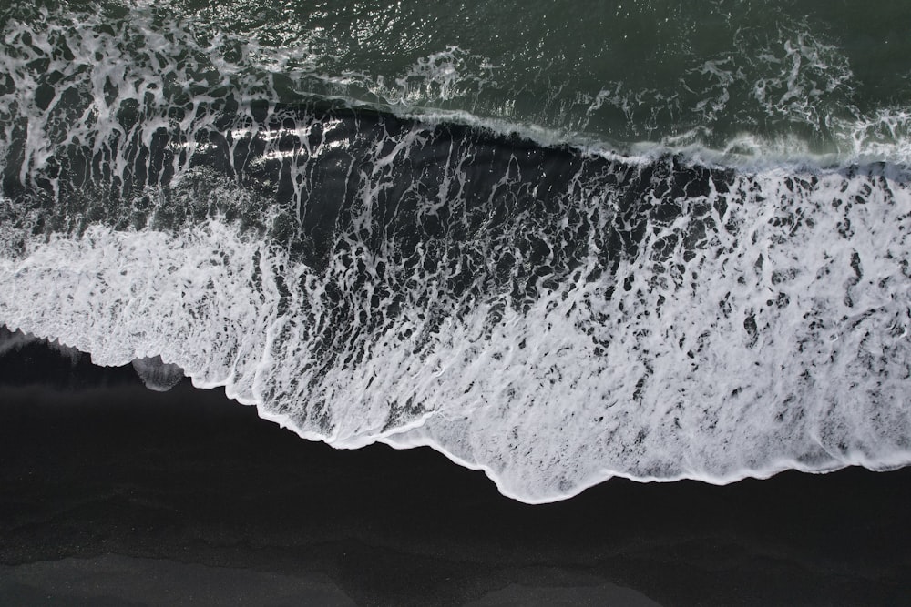 a black and white photo of the ocean waves