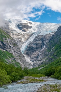 a river running through a lush green valley