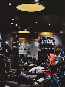 A friendly consultant discussing motorcycle options with a customer in a bright office.
