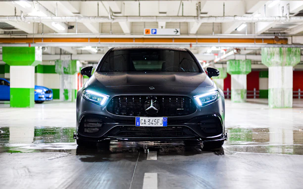 A sleek car parked safely in a well-lit, secure parking spot near Alicante Airport.