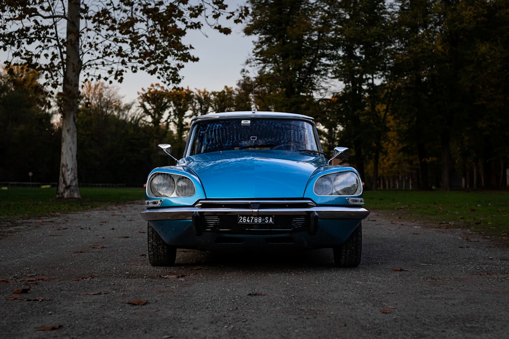 a blue car parked on the side of a road