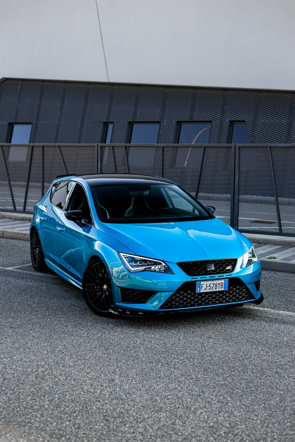 a blue car parked on the side of the road