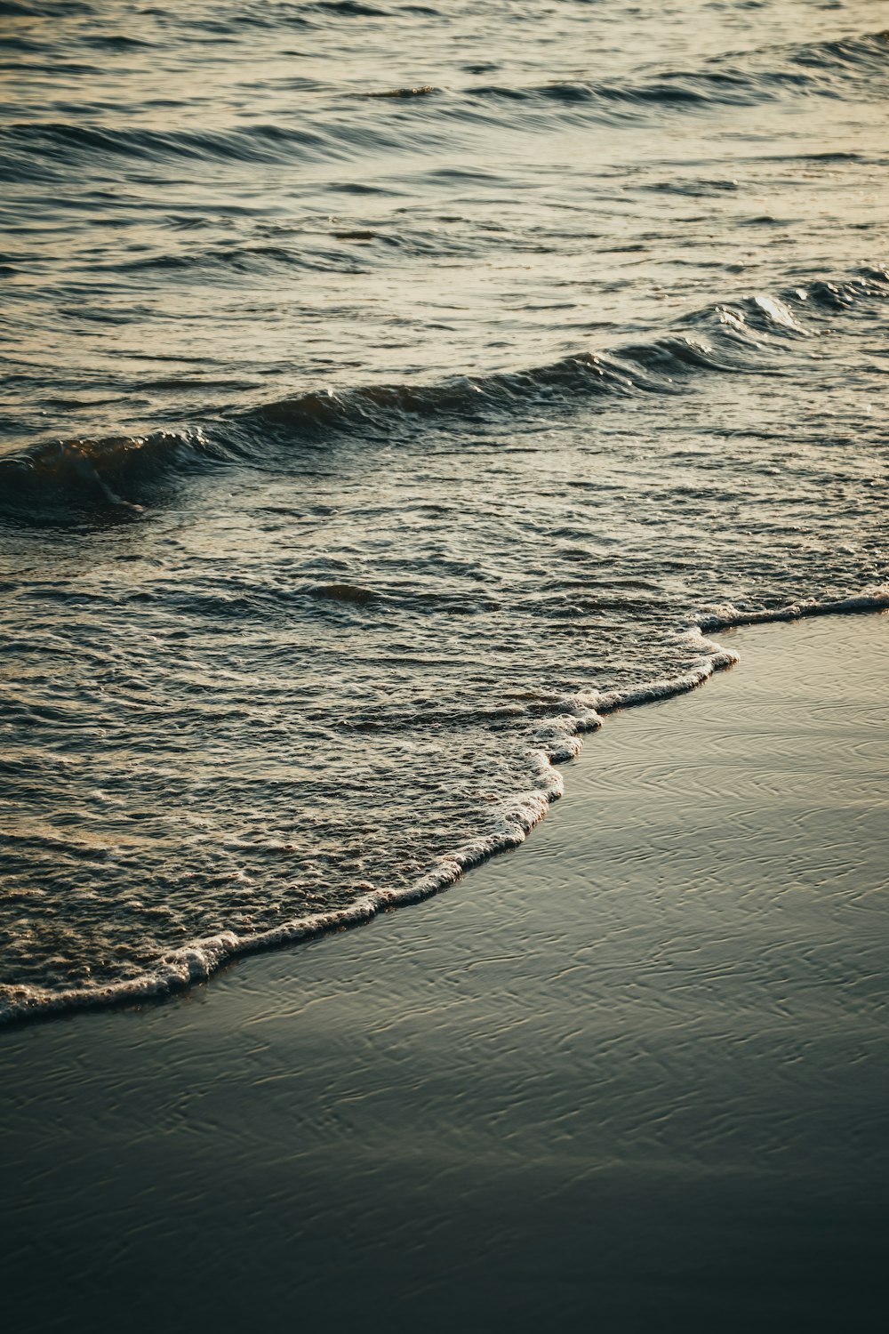 a beach with waves coming in to shore