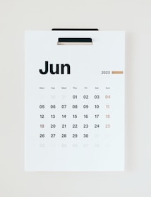 A minimalistic wall calendar displaying the month of June 2023. The calendar has a clean design with bold black typography for the days of the week and numbers. Sundays are highlighted in light brown, while the rest of the days are in black.