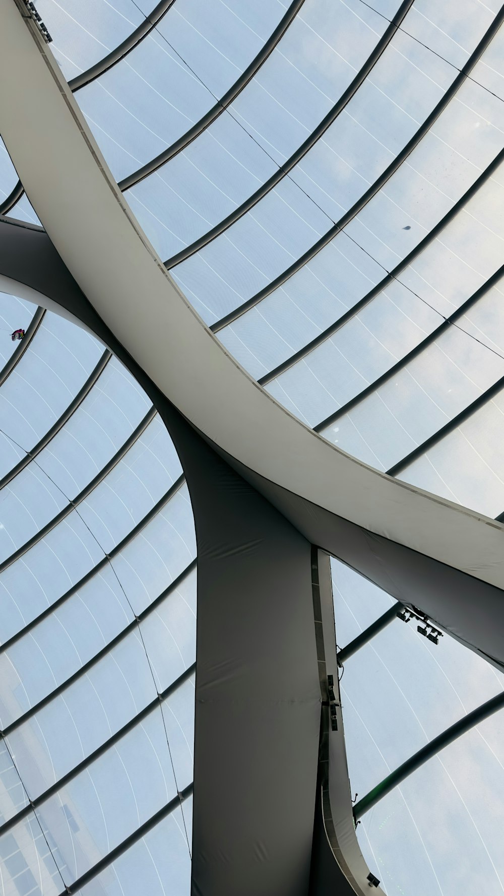 a curved metal structure with a sky background