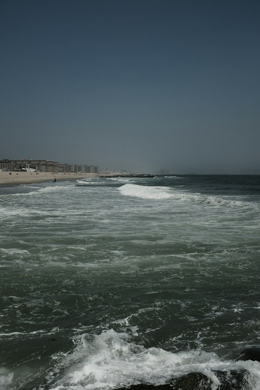 a body of water with waves coming in to shore