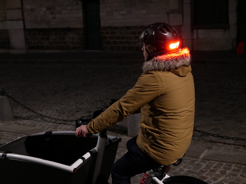 a person riding a bike with a helmet on