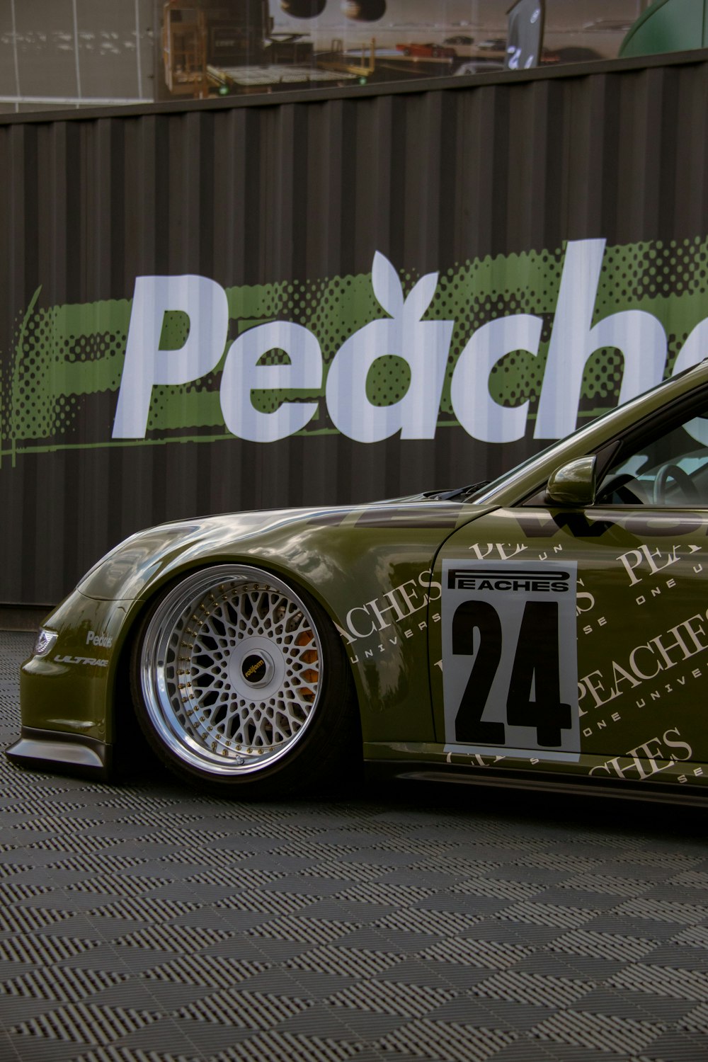 a green sports car parked in front of a building