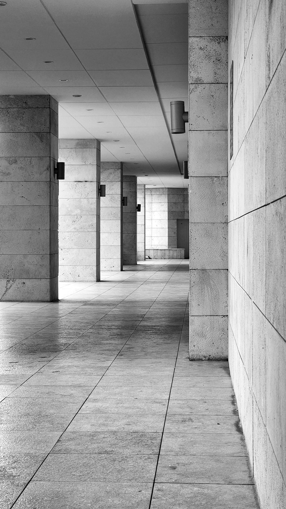 a black and white photo of a long hallway