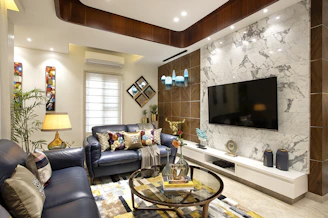 a living room filled with furniture and a flat screen tv