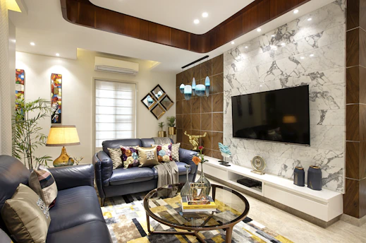 a living room filled with furniture and a flat screen tv