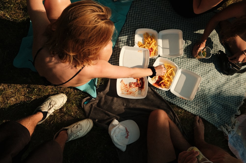 a group of people sitting around a table eating food