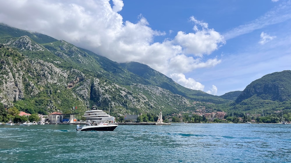 a boat is in the water near a mountain