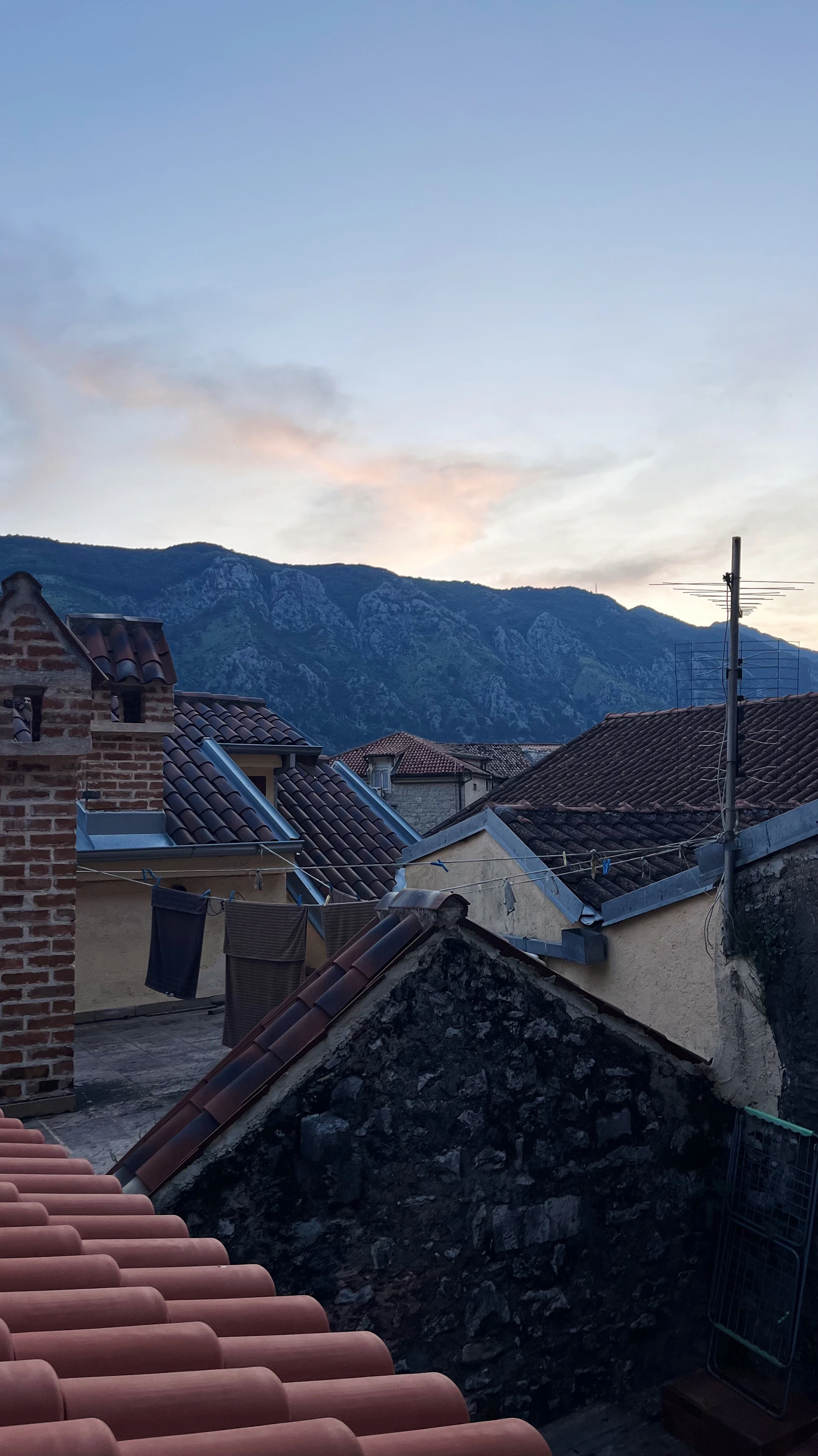 a view of a mountain range from a rooftop