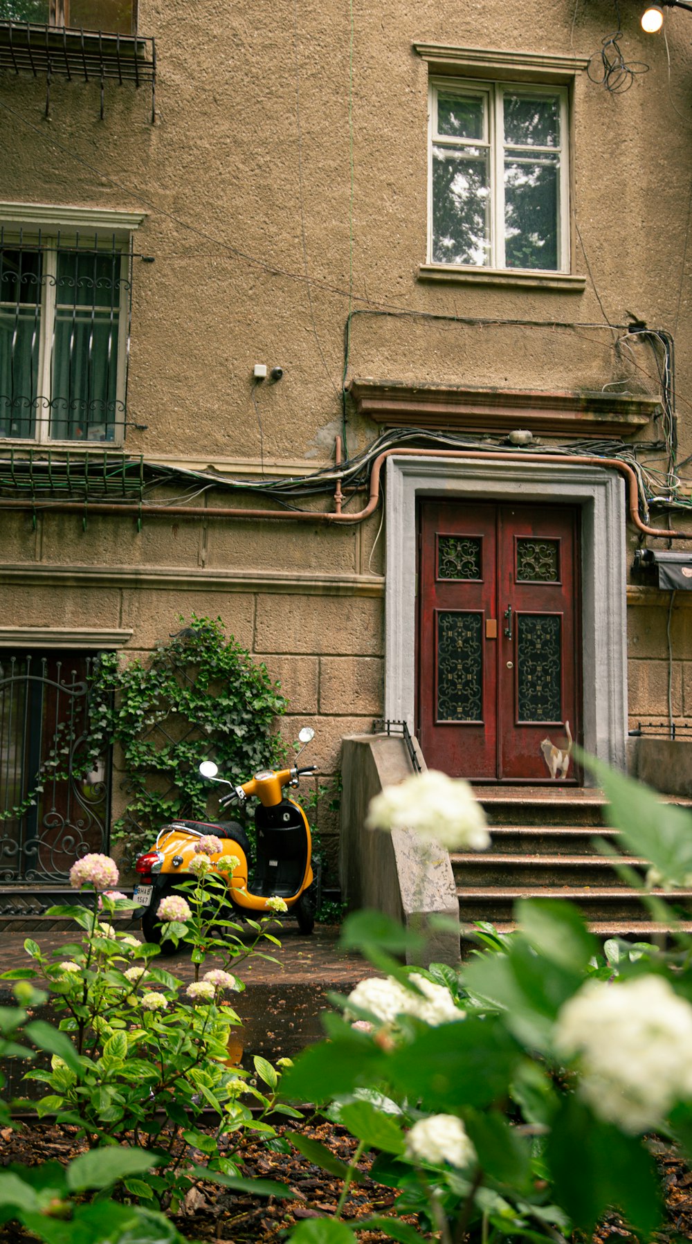 a scooter is parked in front of a house