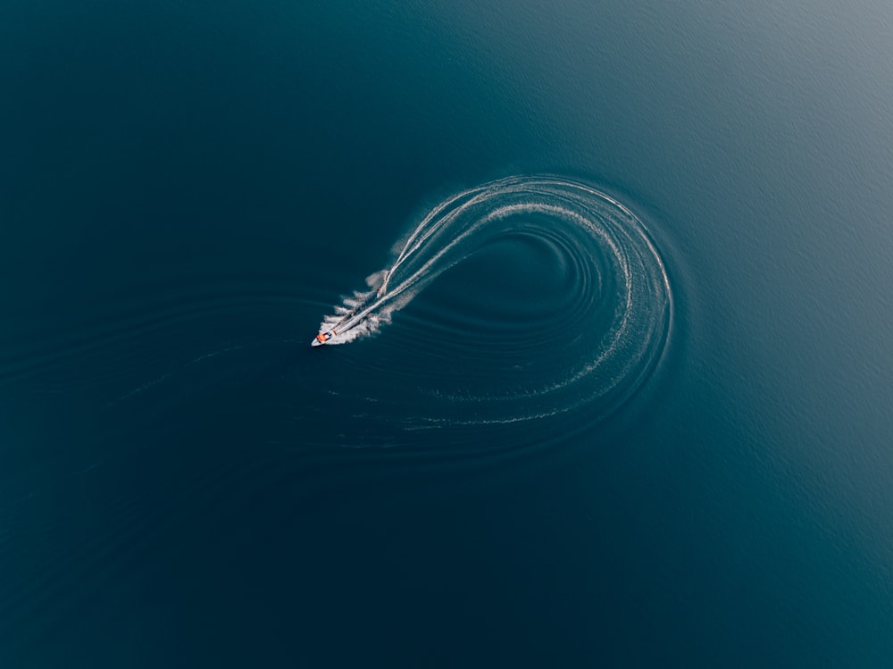 a small boat in the middle of a large body of water