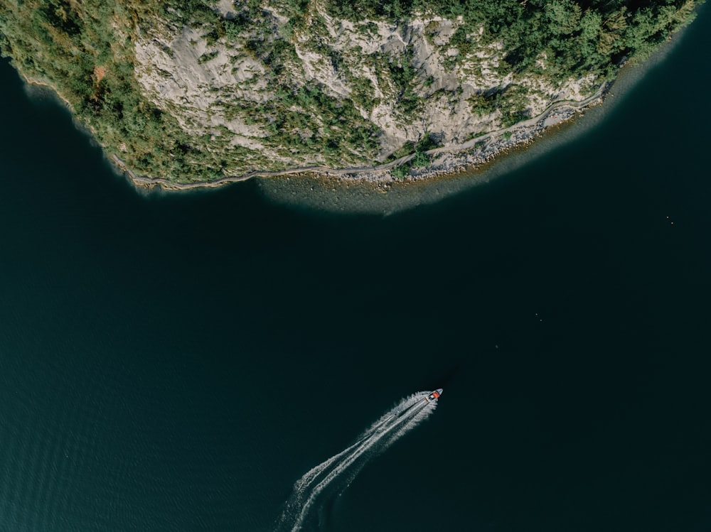 an aerial view of a boat in a body of water