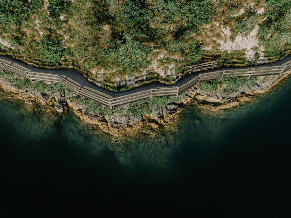 an aerial view of a winding road near the ocean
