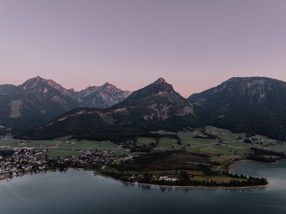 a small island in the middle of a lake surrounded by mountains