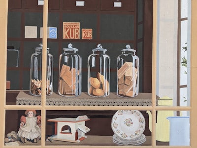 A cozy kitchen scene with jars of fish products lined up beside a basket of freshly baked crackers.