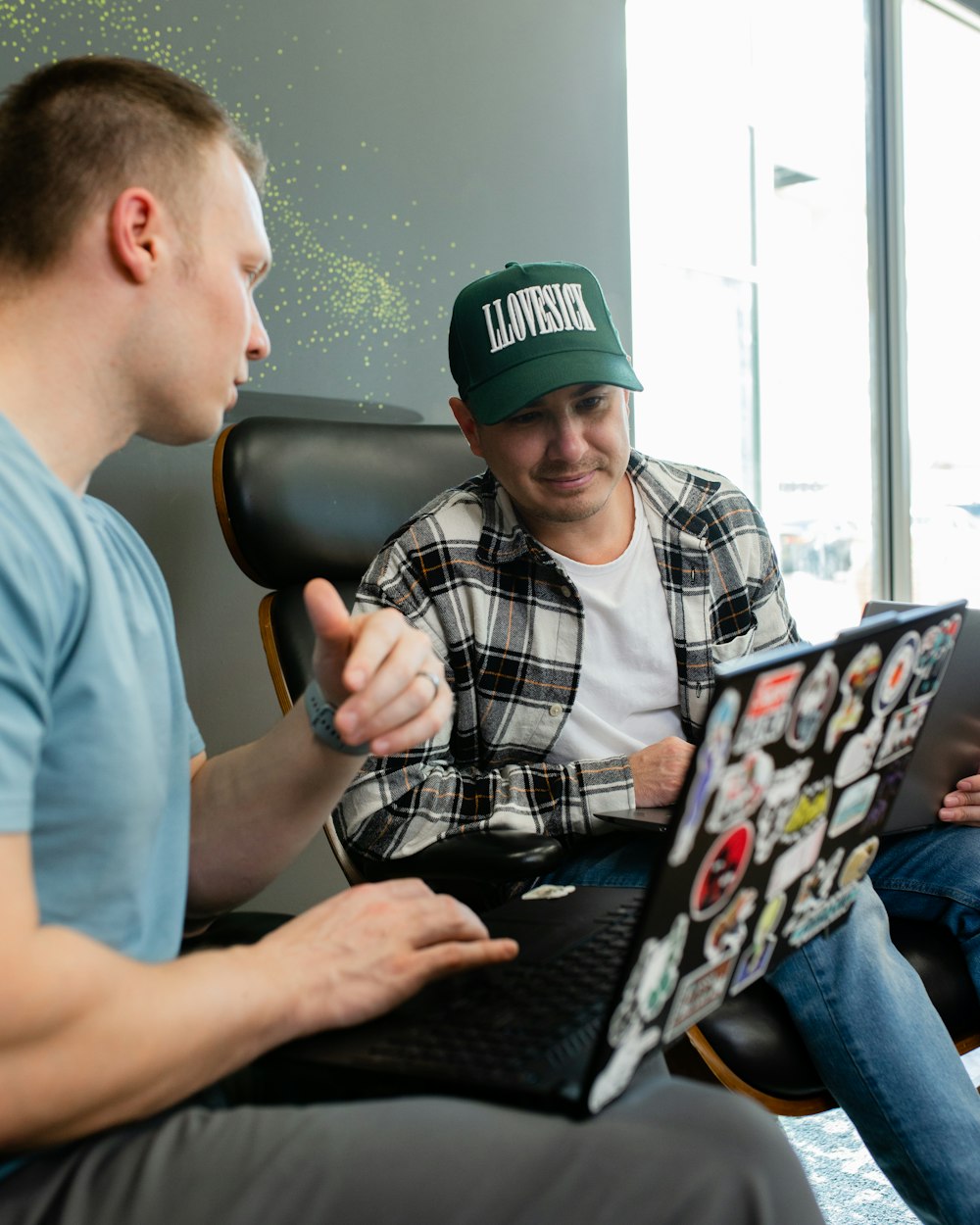 a man sitting in a chair with a laptop