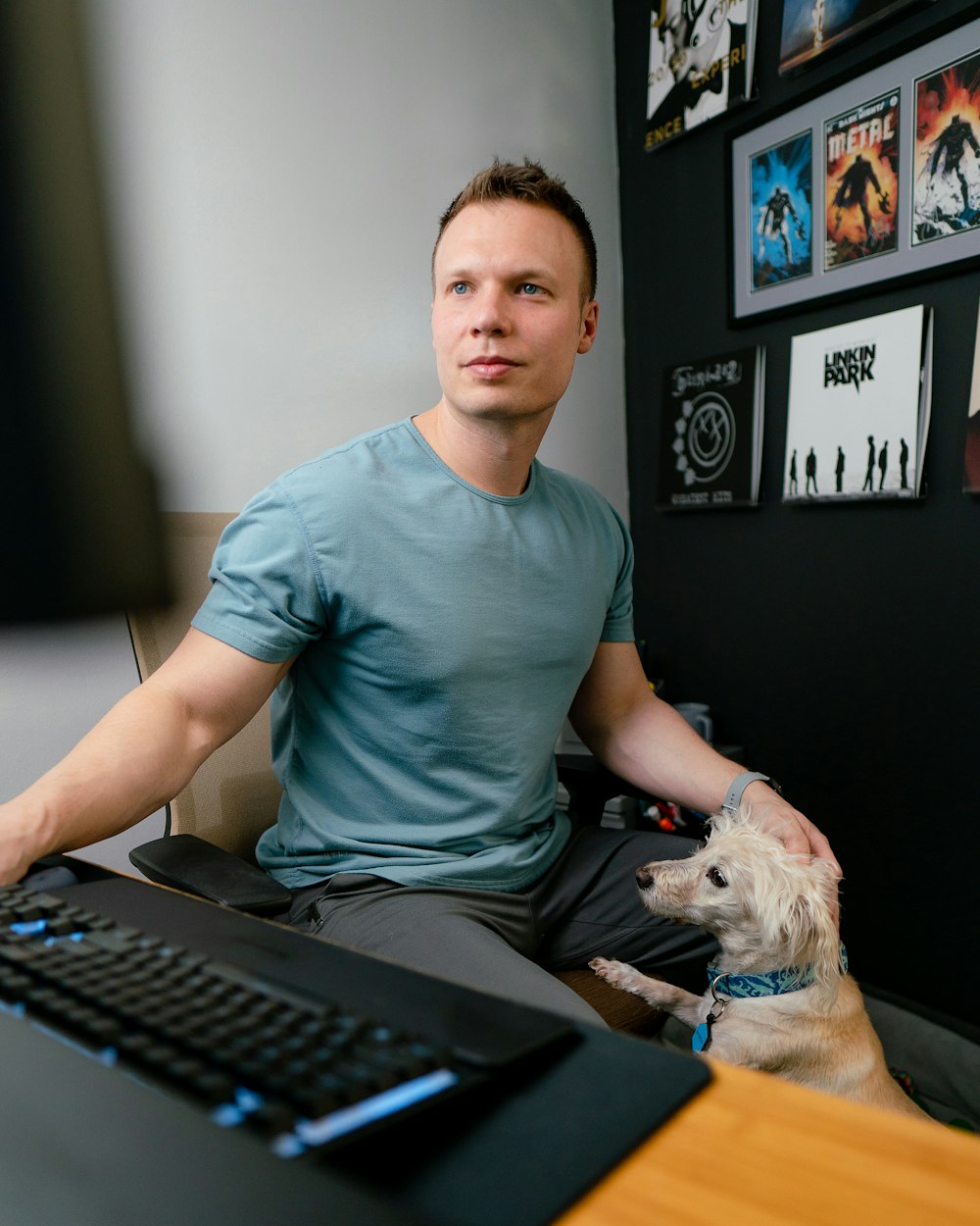 a man sitting at a desk with a dog in front of him