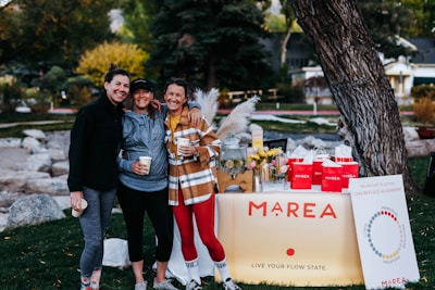 A group of friends in Lumina Apparel activewear laughing together in a city park.