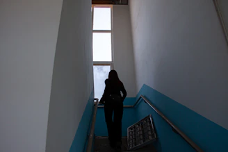 A senior happily using a newly installed stairlift in a bright, welcoming home.