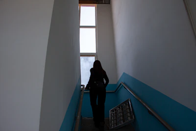 A senior happily using a newly installed stairlift in a bright, welcoming home.