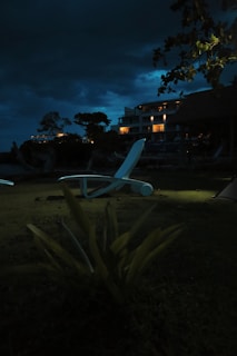 A peaceful outdoor area with comfortable lounge chairs under a night sky.