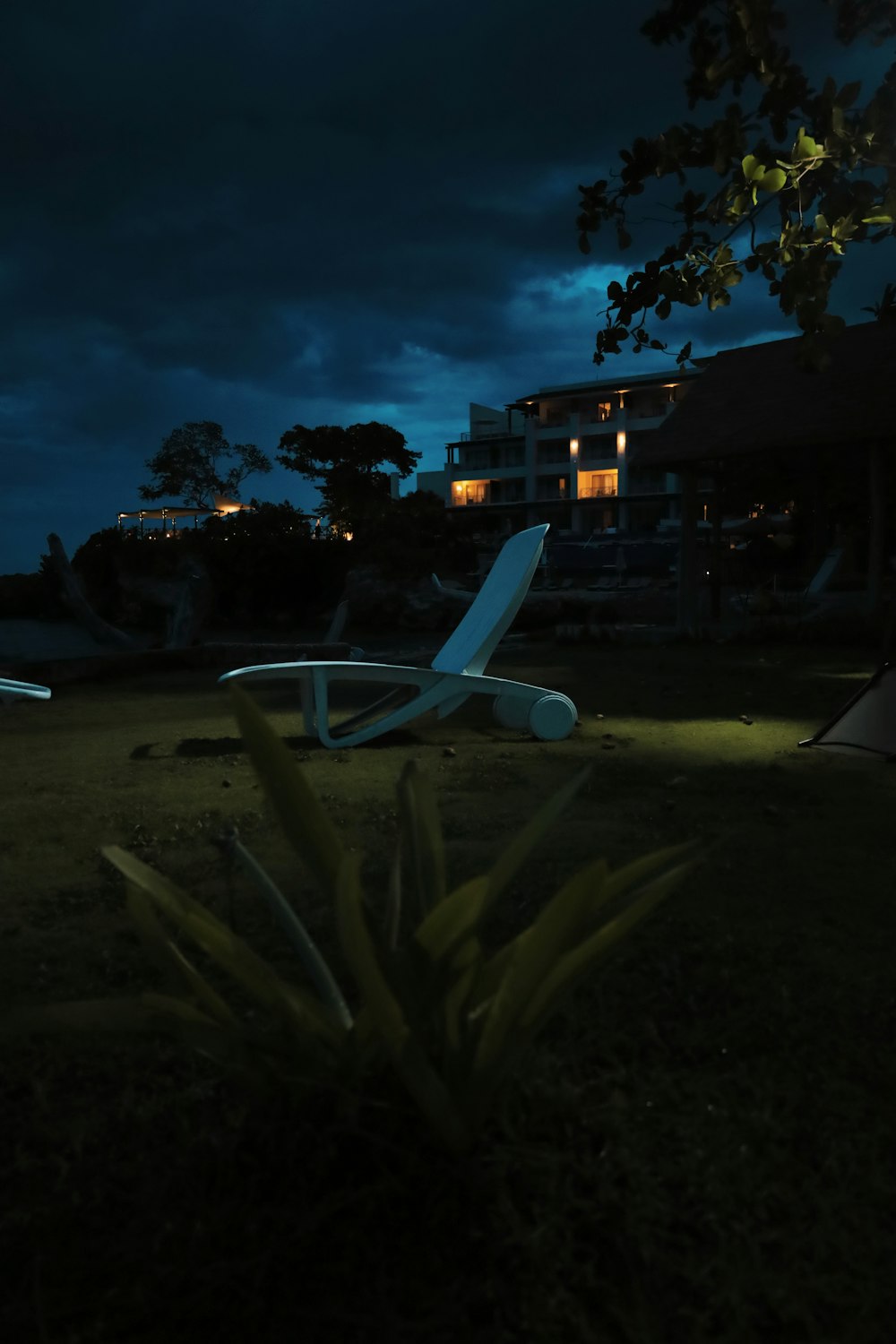 a lawn chair sitting on top of a lush green field