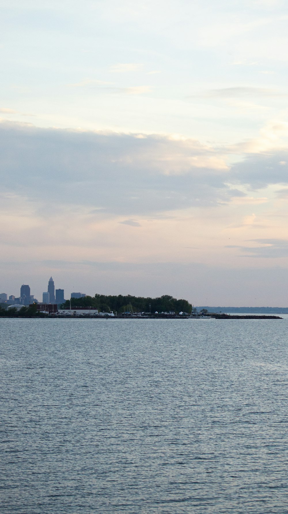 a large body of water with a city in the background