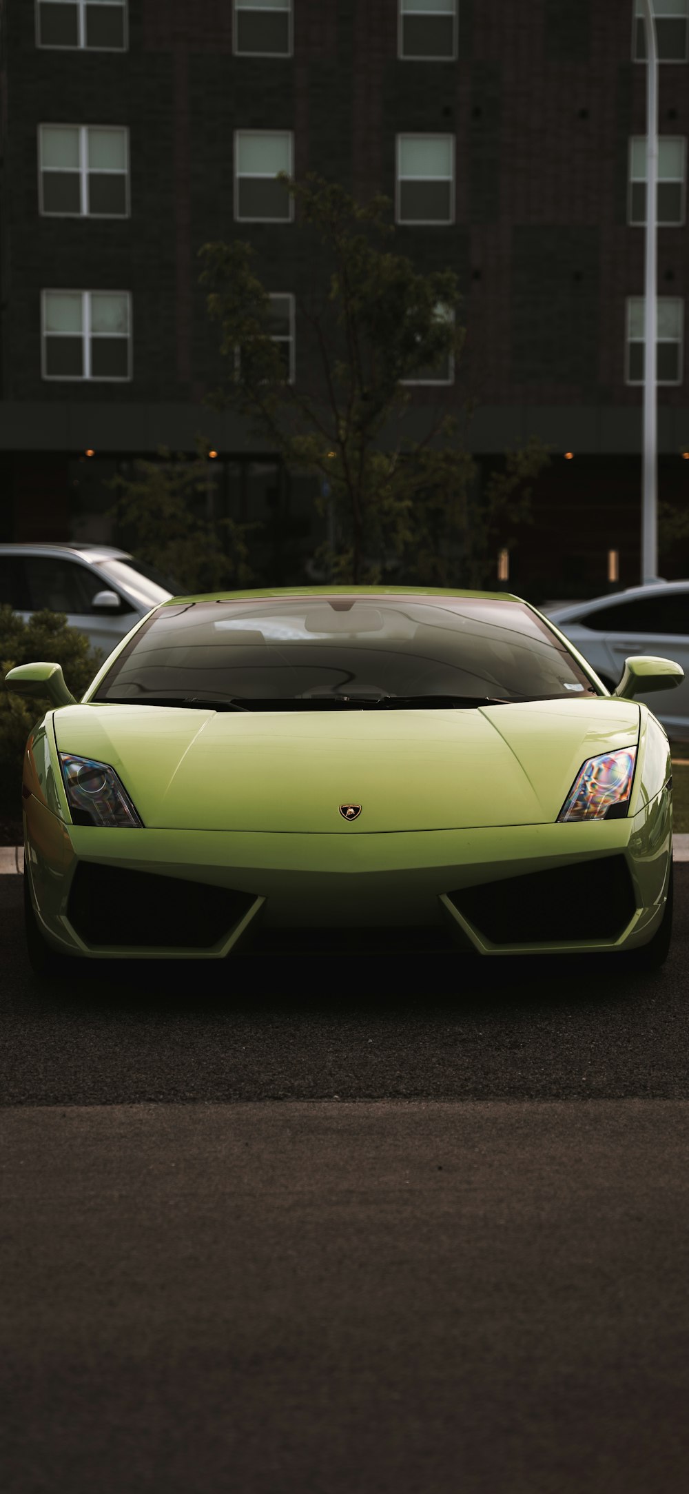 a lime green sports car parked in a parking lot