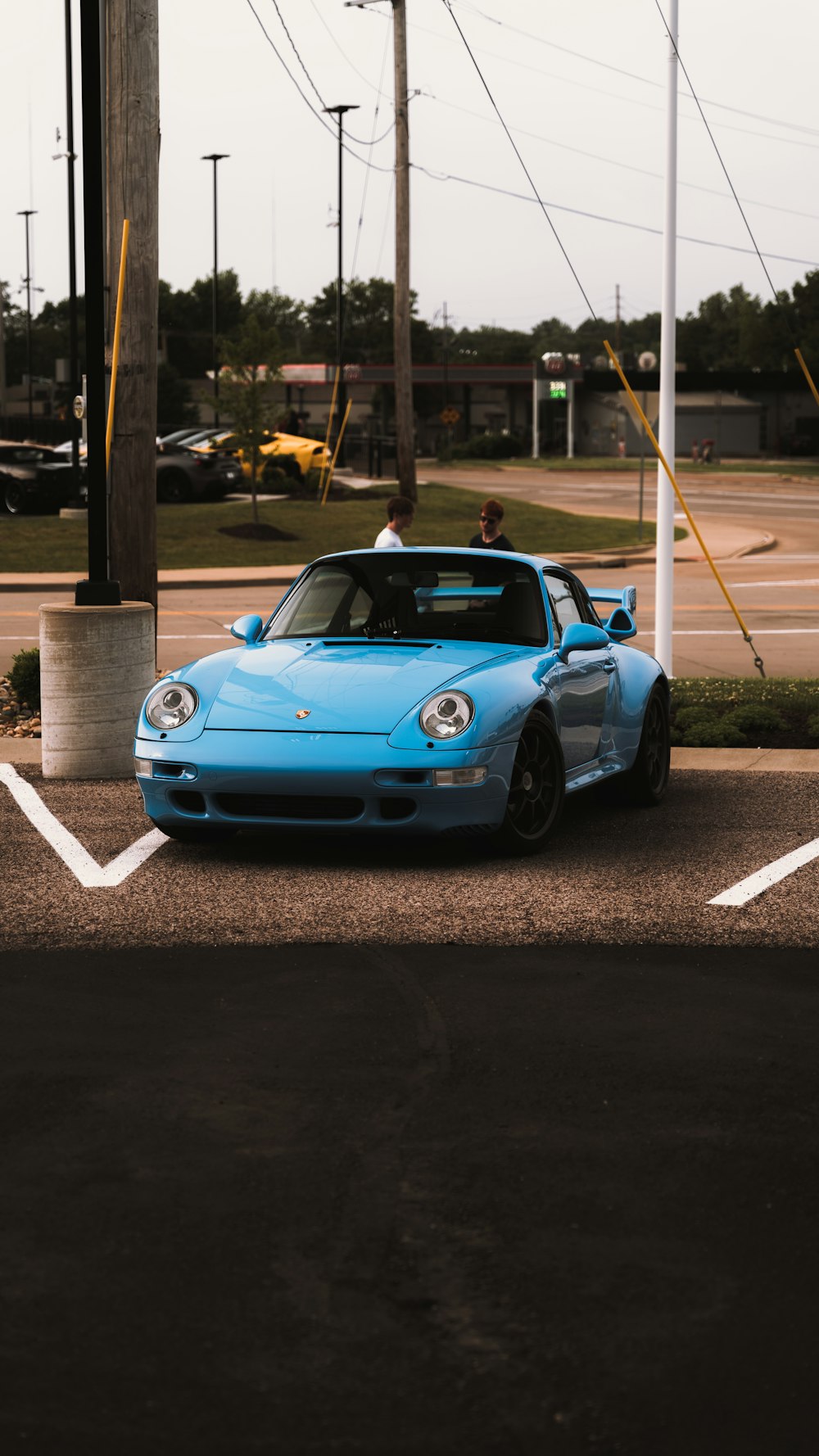 a blue sports car parked in a parking lot