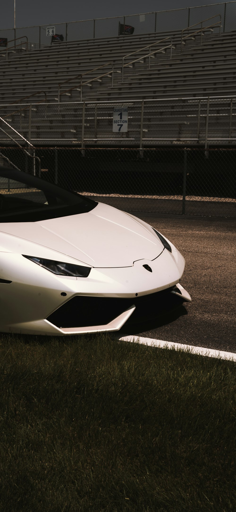 a white sports car parked on the side of the road