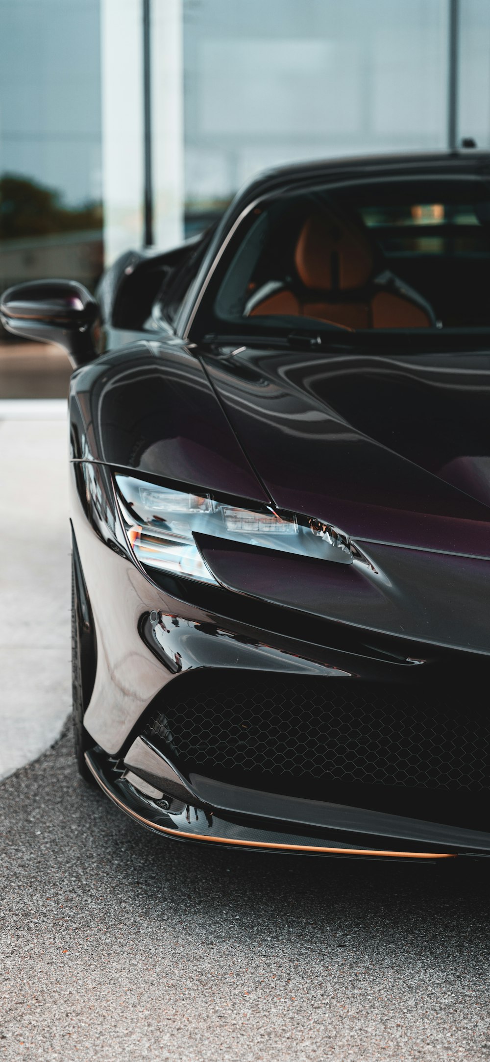 a black sports car parked in front of a building