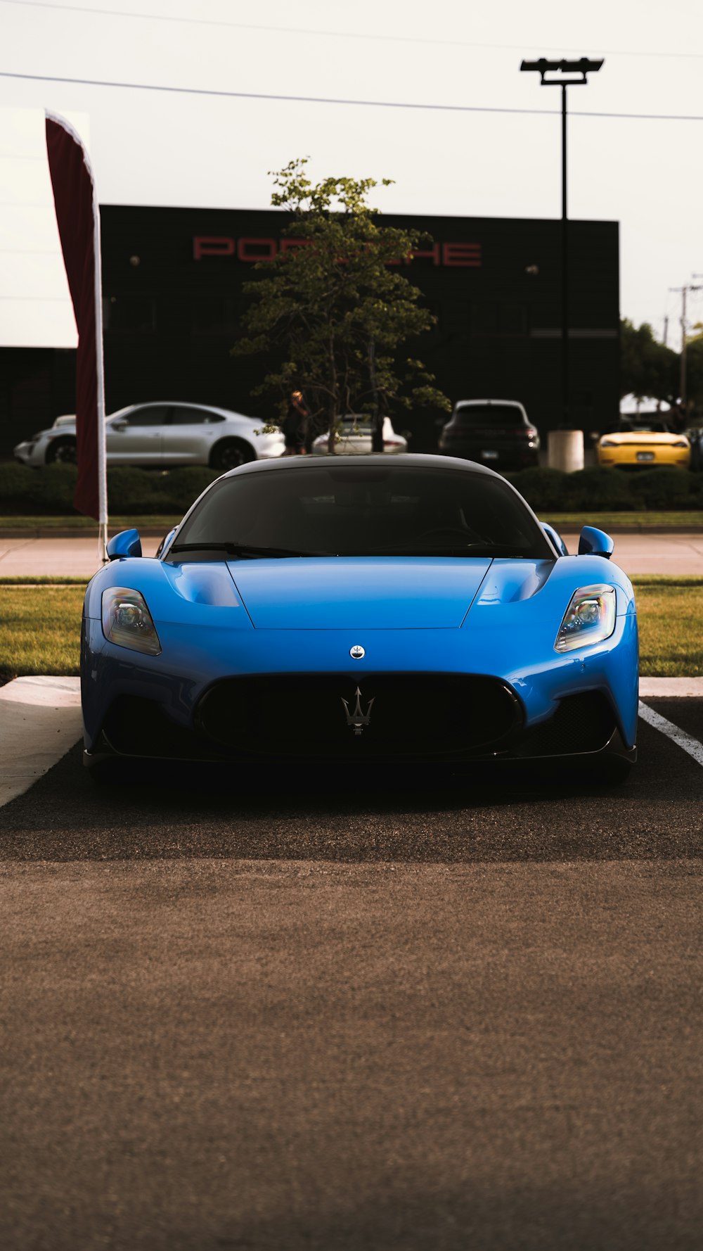 a blue sports car parked in a parking lot