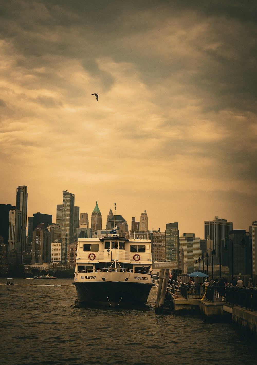 a large boat in the water with a city in the background