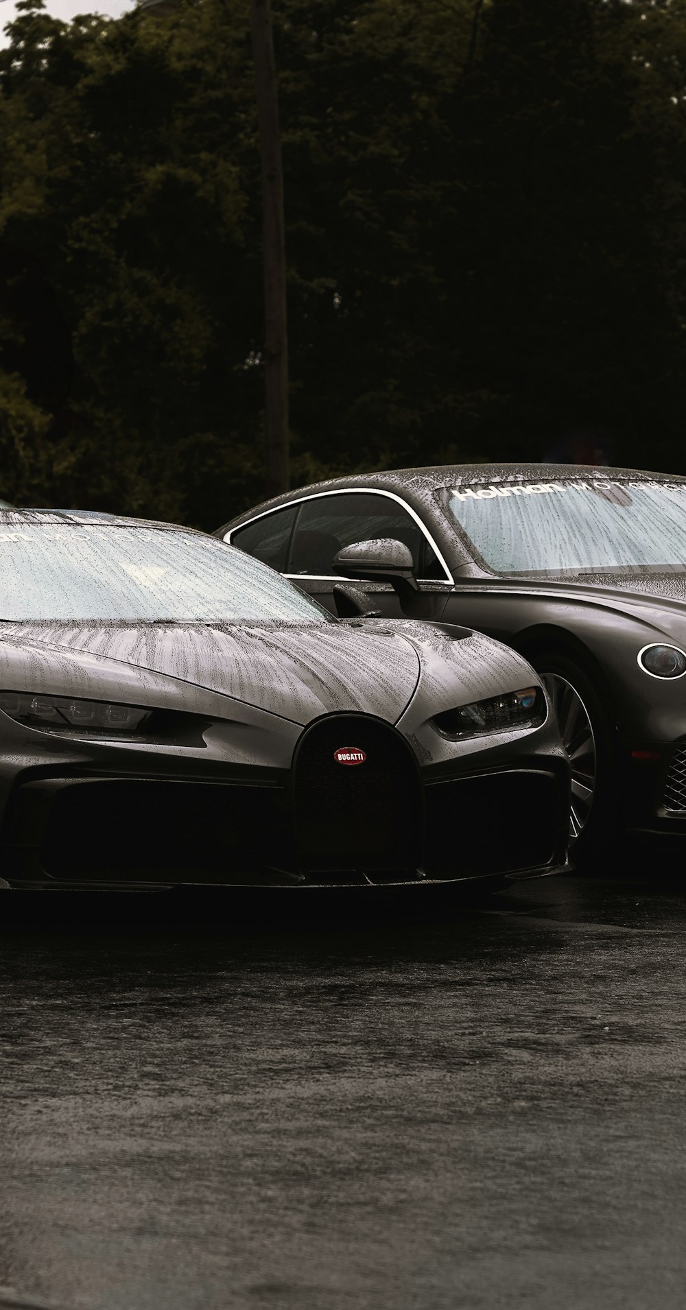 a couple of black cars parked next to each other