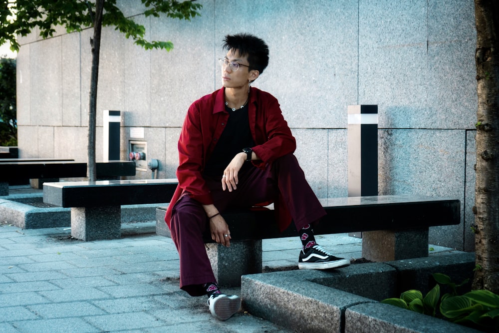 a man sitting on a bench in front of a building