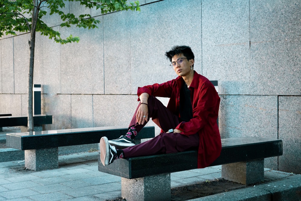 a man sitting on a bench in front of a building