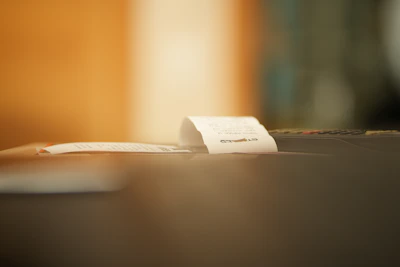 Close-up of a thermal Epson printer rapidly printing receipts in a busy restaurant kitchen.