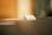 A close-up of a small paper receipt partially protruding from a machine, likely a cash register or printer. The background is softly blurred, creating a warm ambiance.