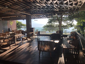 Inviting terrace seating with natural wood furniture and soft ambient lighting.