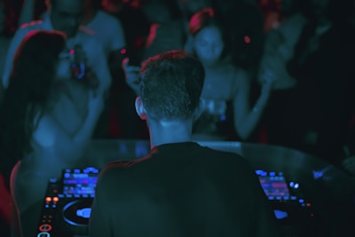 A DJ performing live at a crowded event.