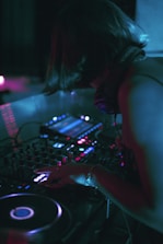 DJ performing live on camera with professional lighting and streaming setup.