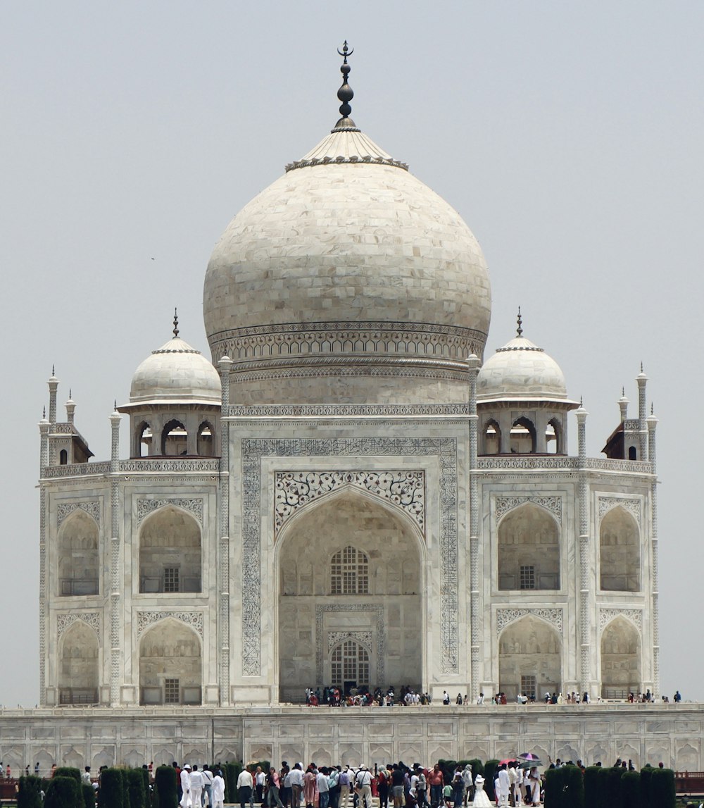 a group of people standing in front of a white building